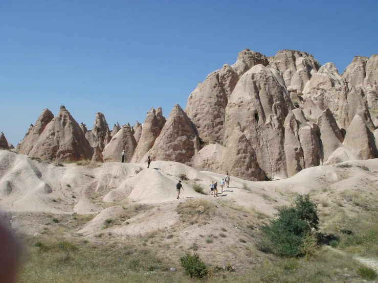 the hikers are in the desert and one is walking along a trail