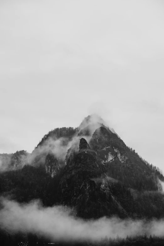 fog covers the mountains and valleys surrounding a city