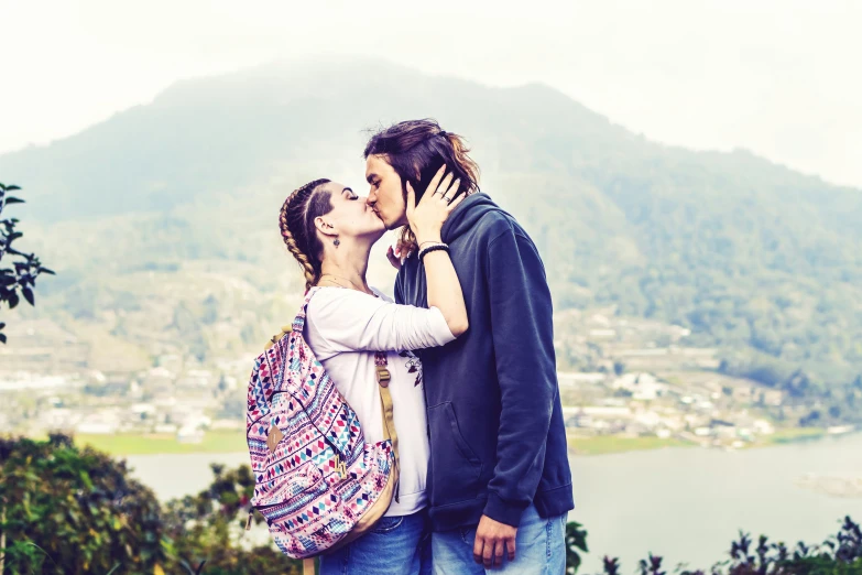 couple kissing with large mountain in the background