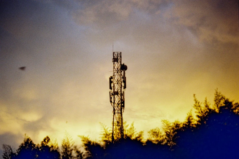 silhouetted view of tower against blue sky at dusk