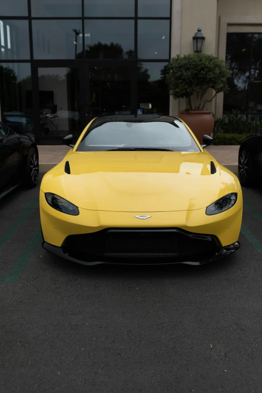 an exotic yellow sports car is parked in the parking lot