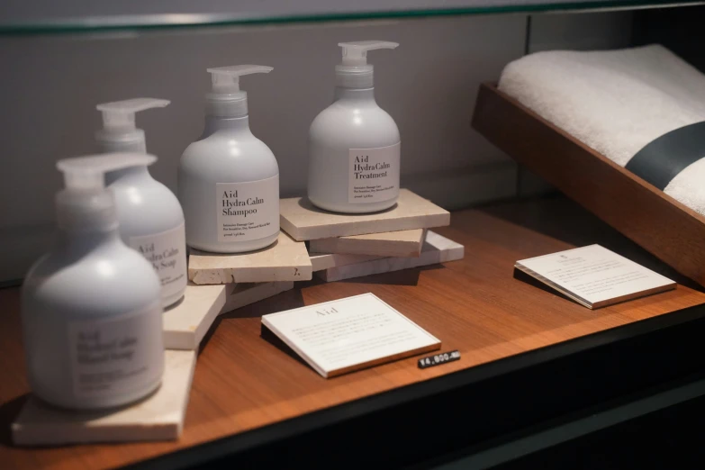 a variety of cleanserines on display on a wooden shelf