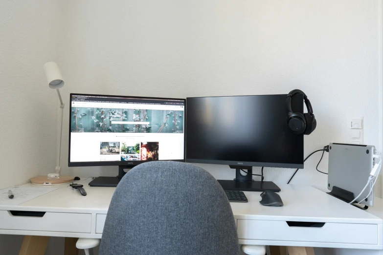 an empty computer desk with a monitor and keyboard on it