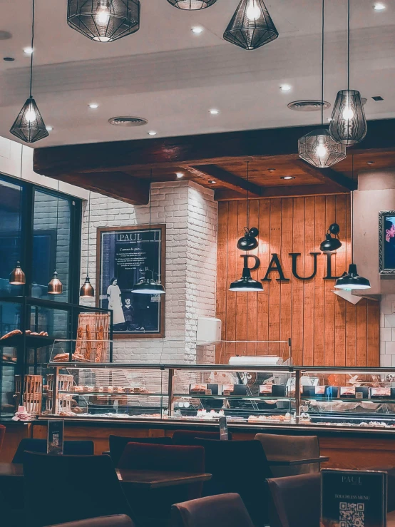 the counter area of a restaurant with wooden walls