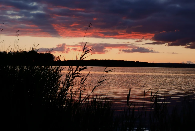 the sky is purple and orange as the sun sets