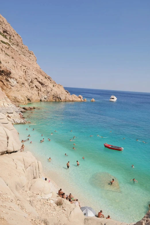 a large group of people and boats on a beach