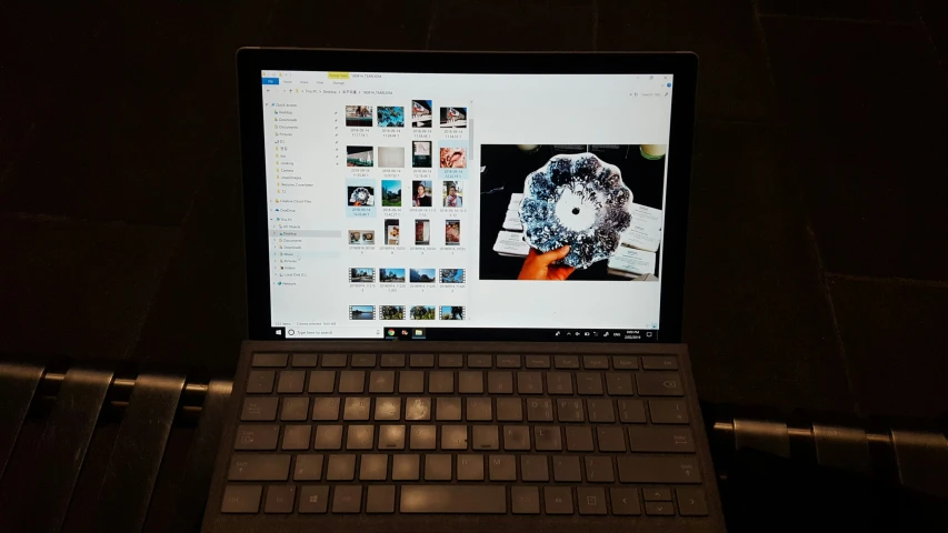 a laptop computer sitting on top of a dark desk