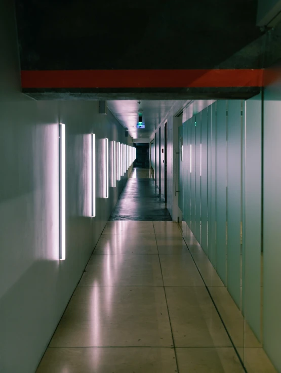a dimly lit corridor inside an airport with no people