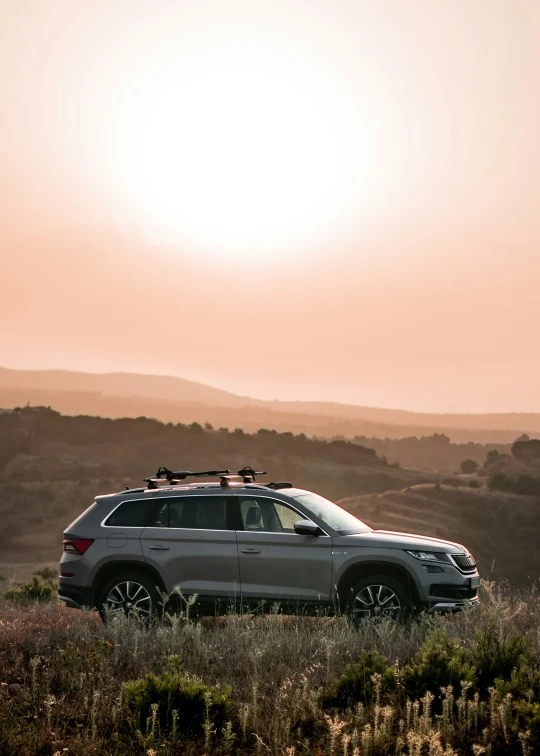 a white suv with skis parked near the mountains