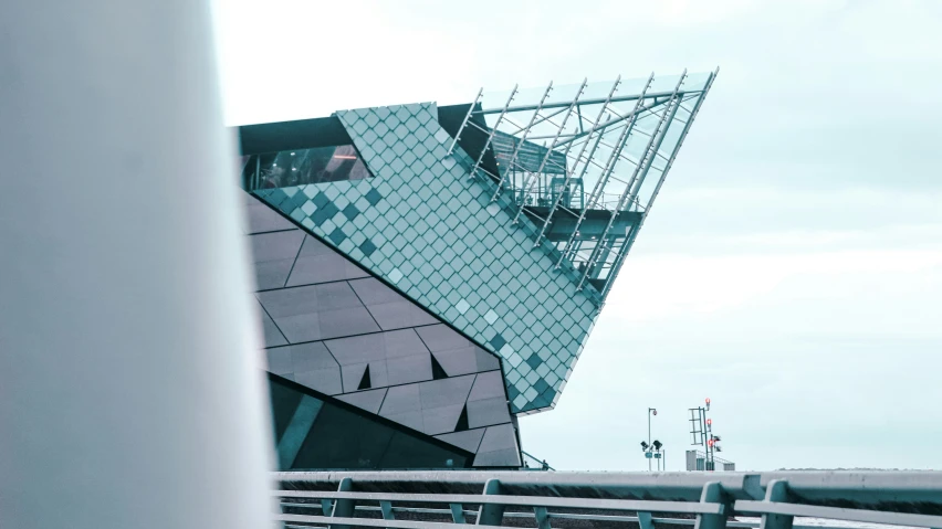 an upside down building with people sitting on the roof