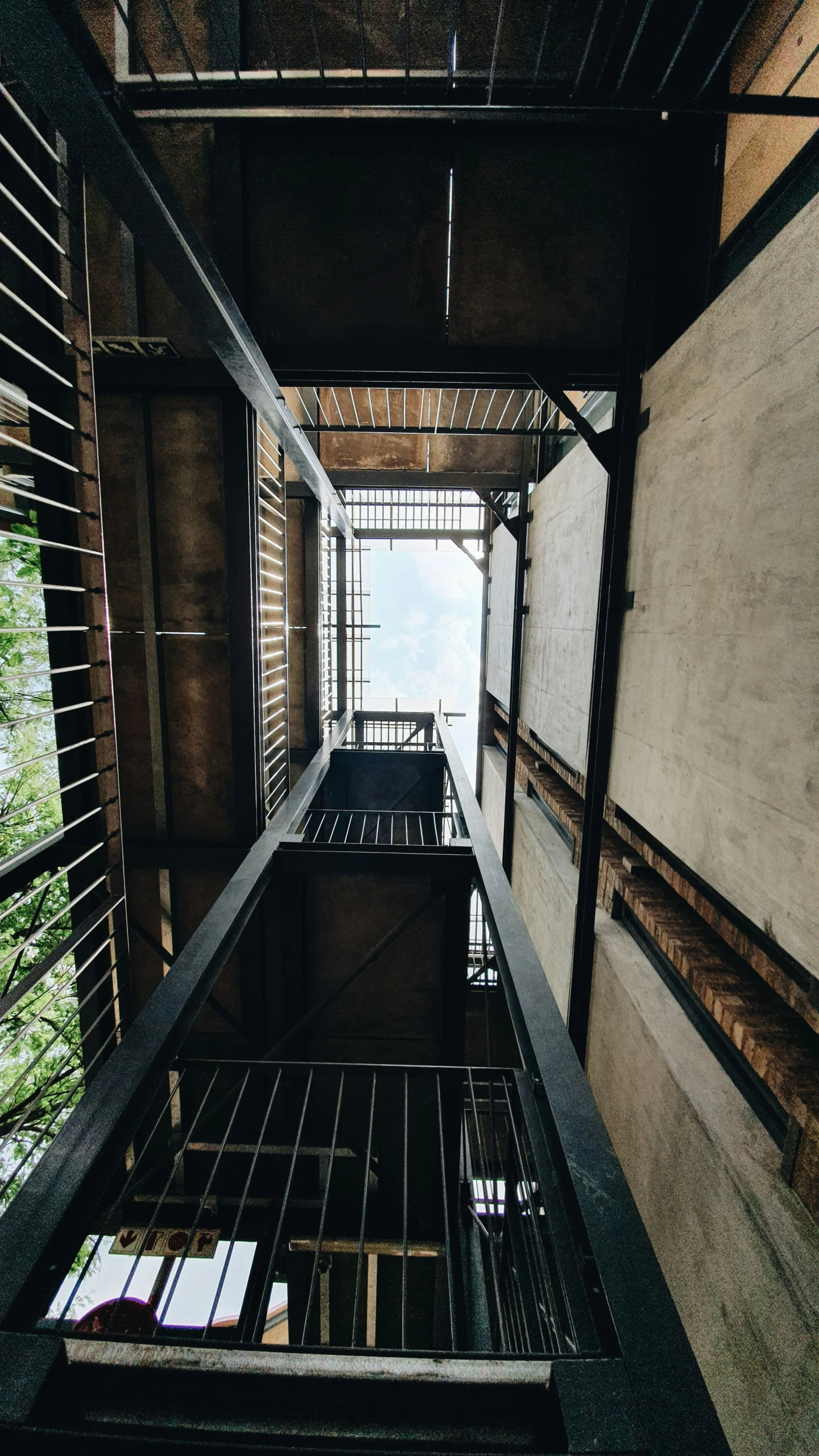 a tall structure with metal balconies and open windows