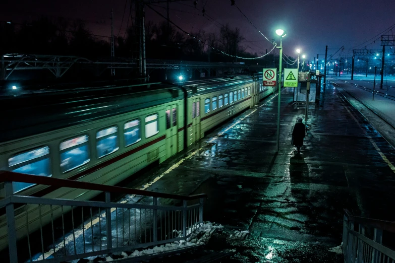 a nighttime train station on its track is empty