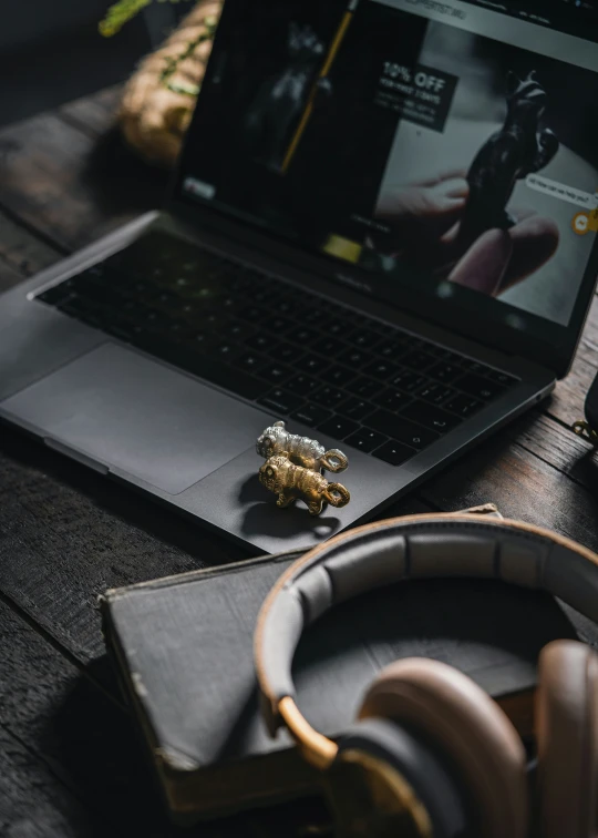 a laptop on a desk with headphones