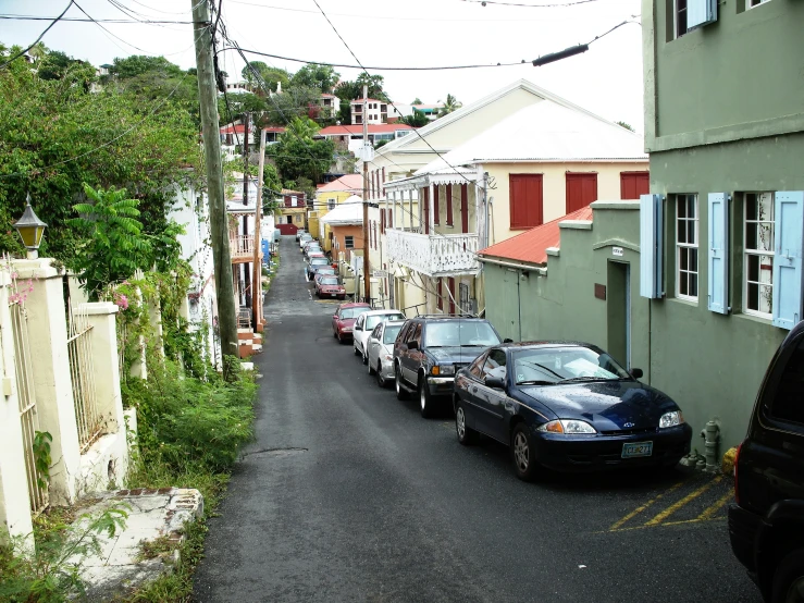 cars parked in side walk on narrow street