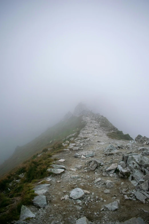 a mountain landscape covered in rocks and fog