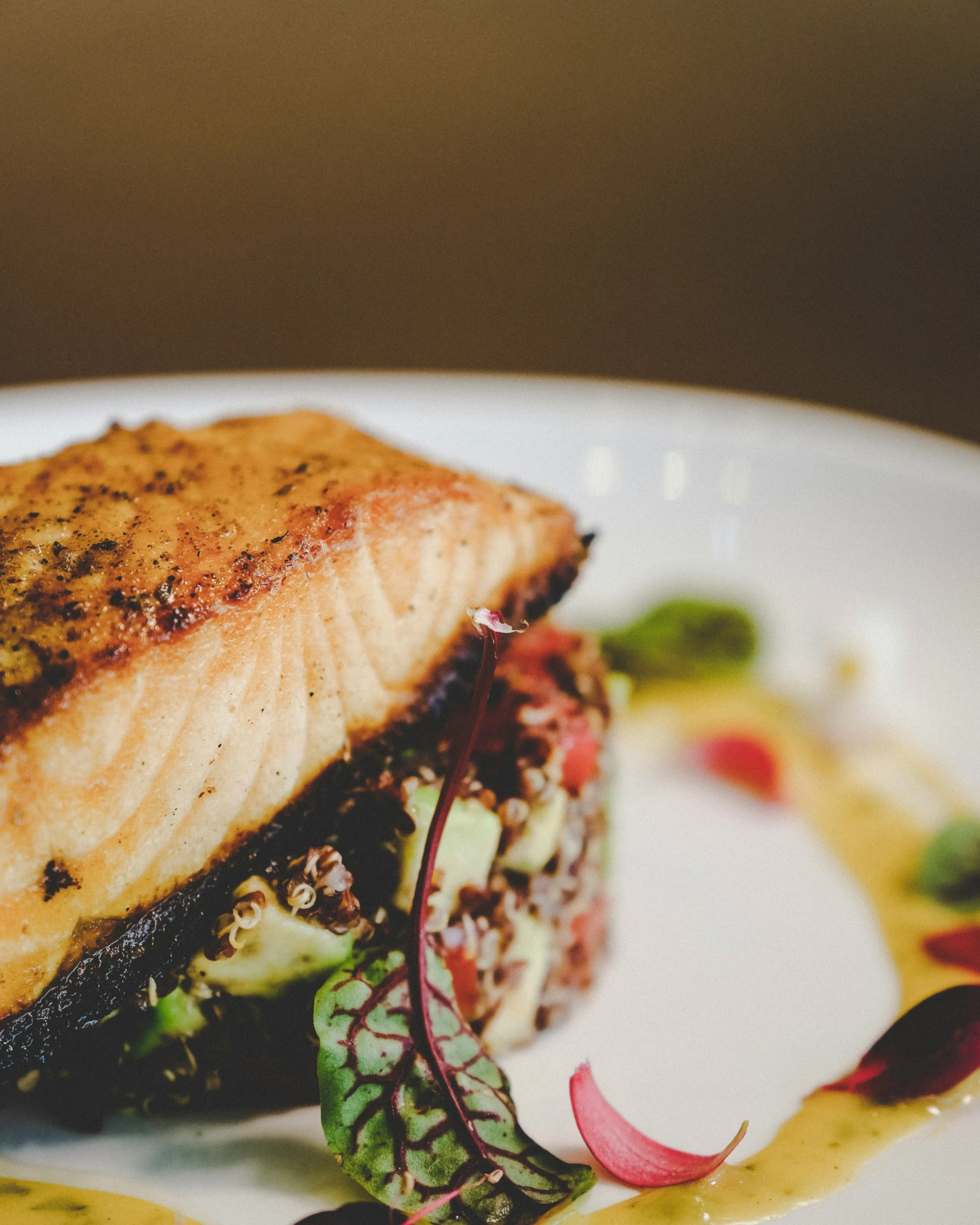 the dish features salmon, lettuce and a colorful salad