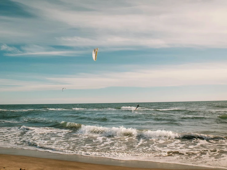 a person windsurfing in the ocean on a sunny day