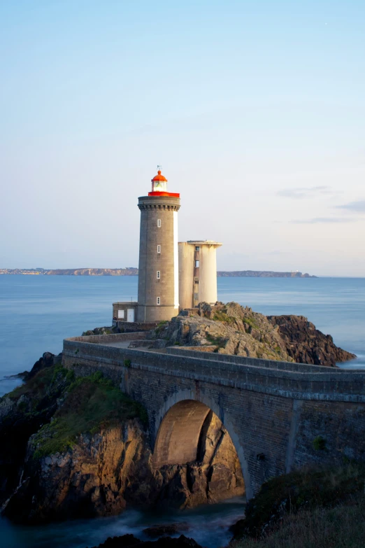 a bridge over looking the ocean and a light house