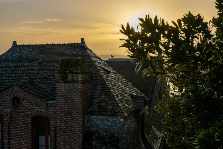 the sun is setting in over an old building