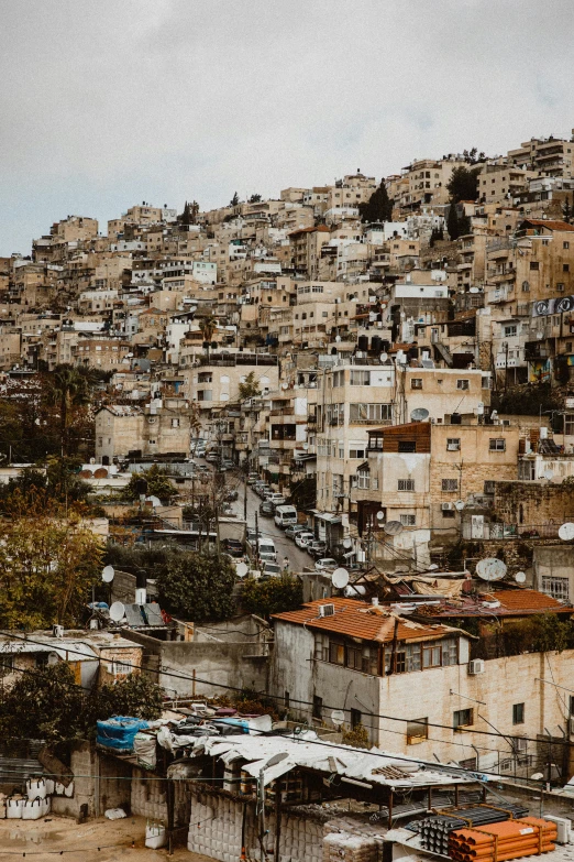 the skyline of a large hill is full of slums