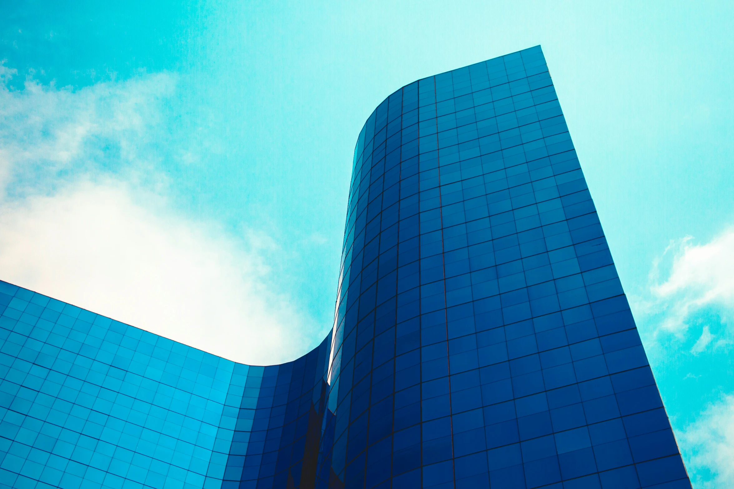 a tall building has very blue windows