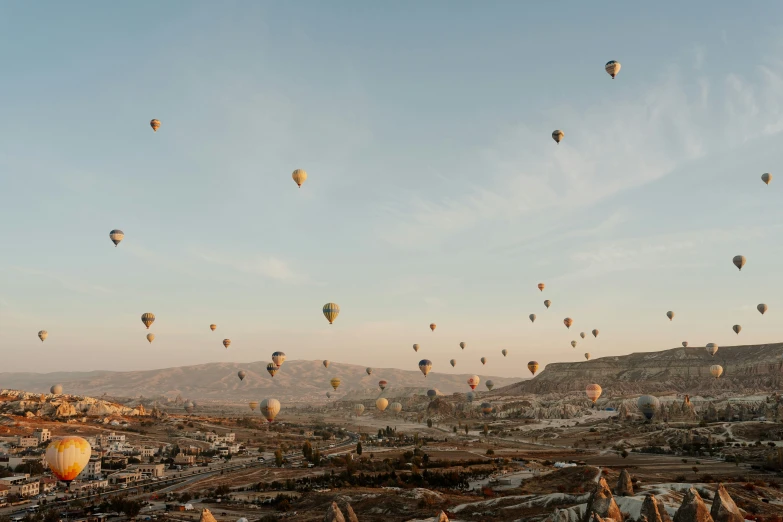  air balloons flying in the sky above a city