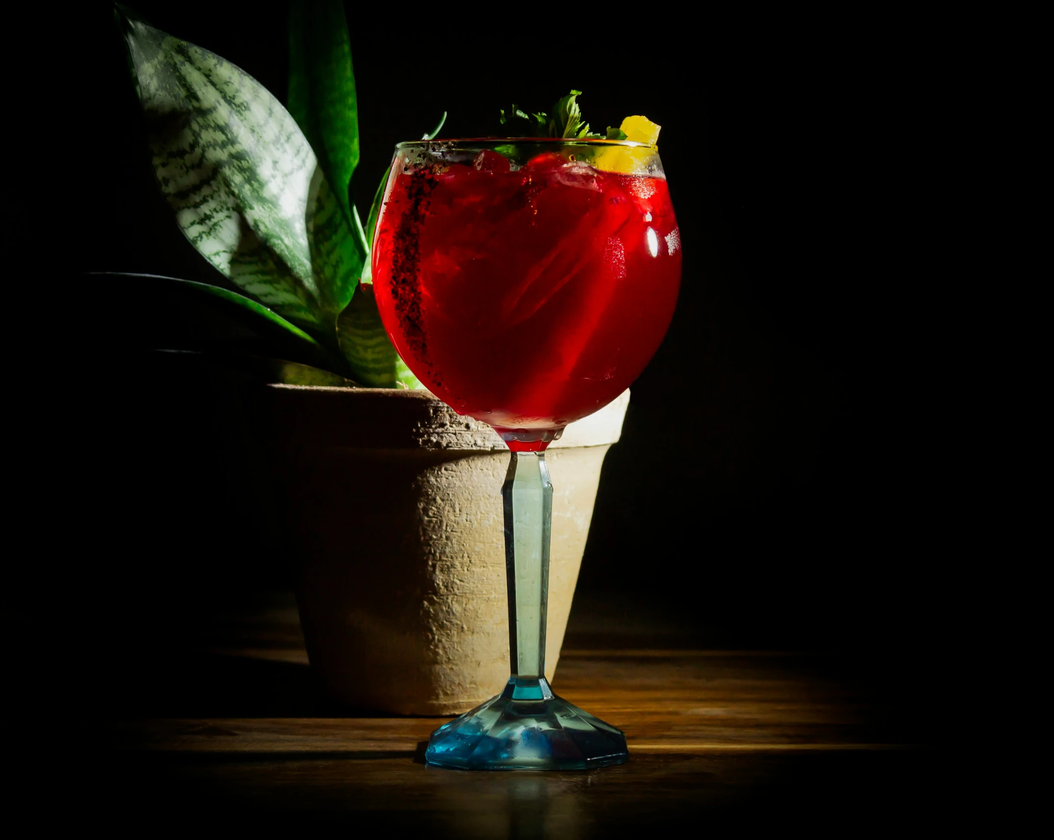 a glass filled with liquid on top of a wooden table