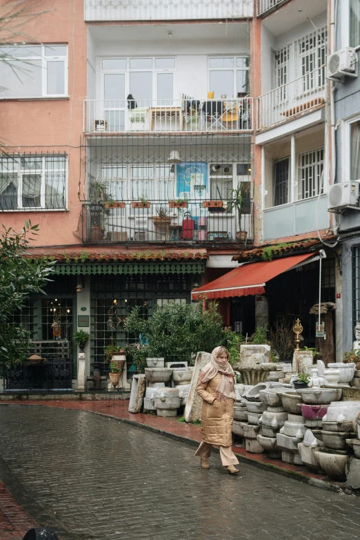 a person walking down an alley next to buildings