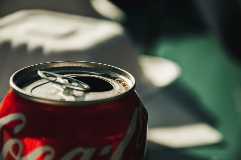 a can of coca cola sitting on a table