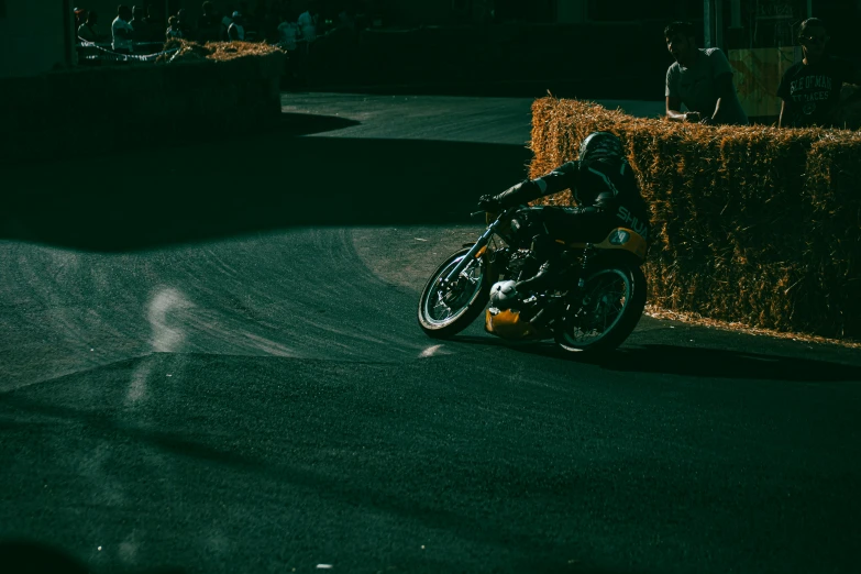 a person riding on the back of a motorcycle down the street