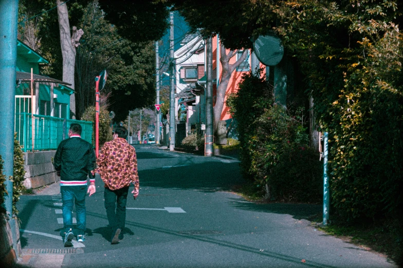 a man and a woman walking down a street with signs