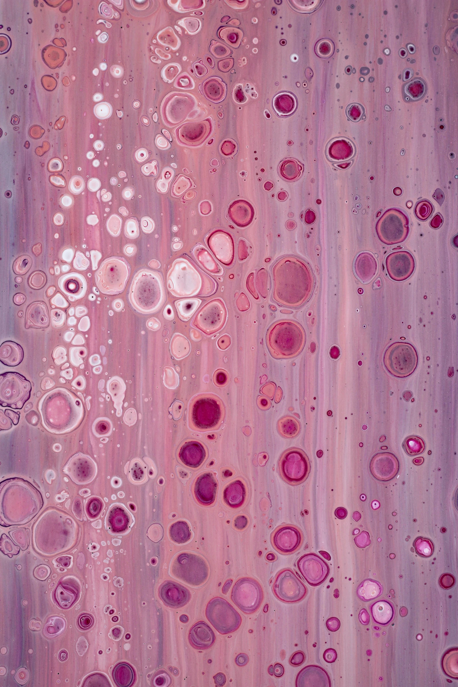 an artistic abstract painting of pink paint and bubbles