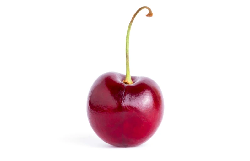 an orange sitting in a red apple with a stem