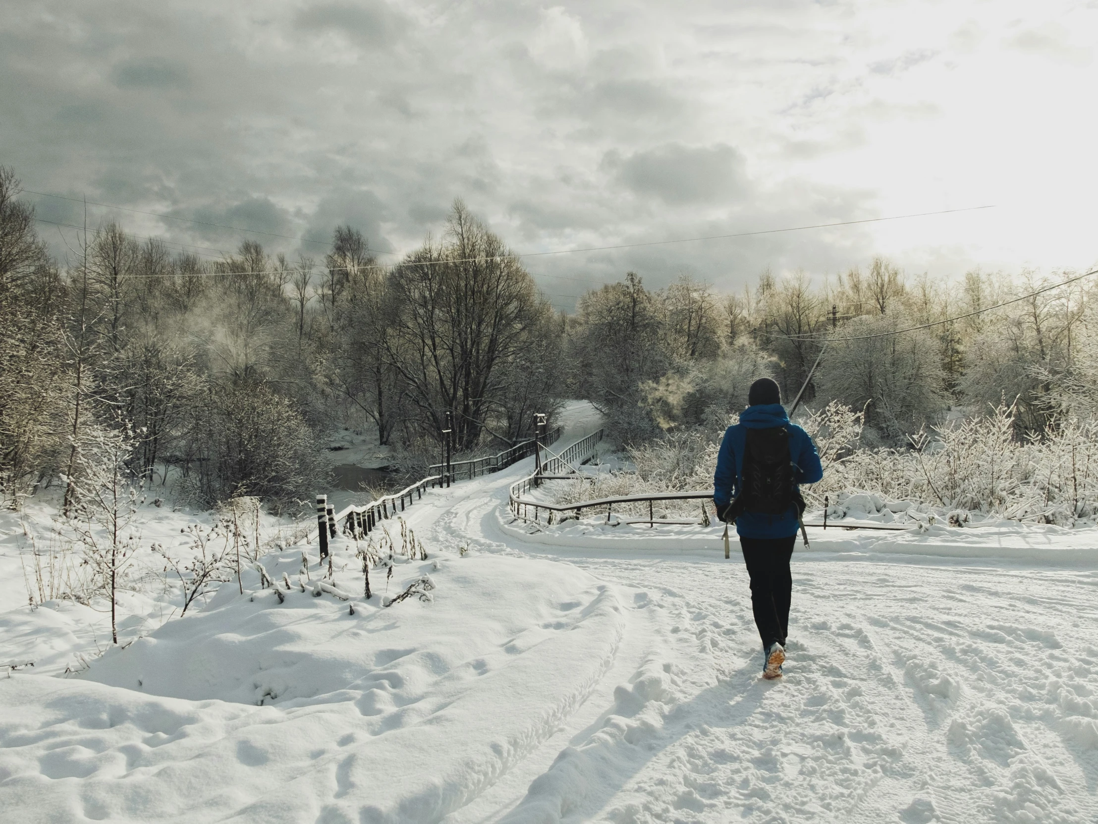 the snow covered ground has a person walking on it