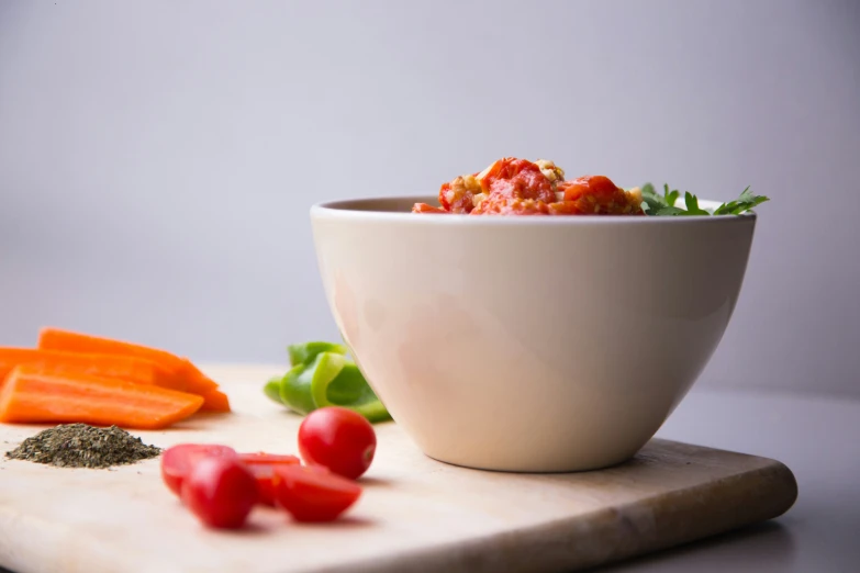 a close up of food on a  board near other vegetables