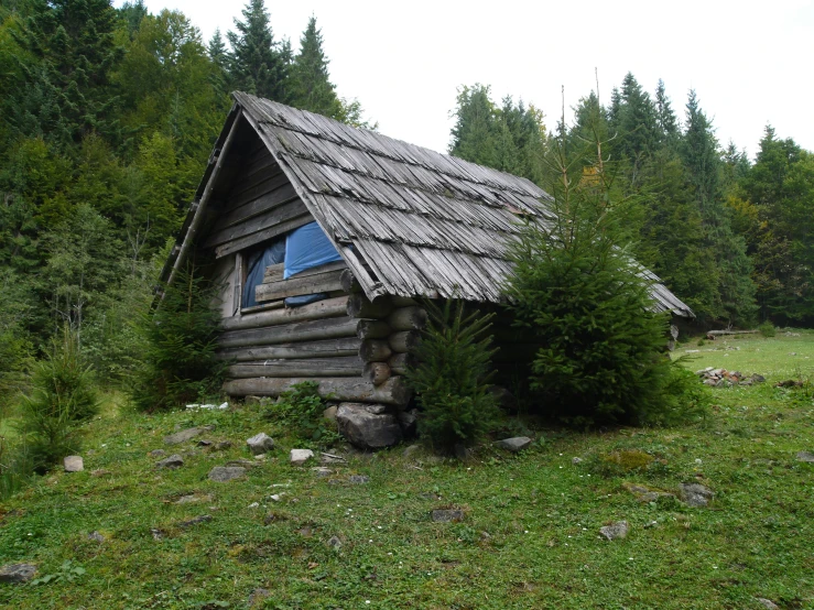 a log cabin with a small blue window