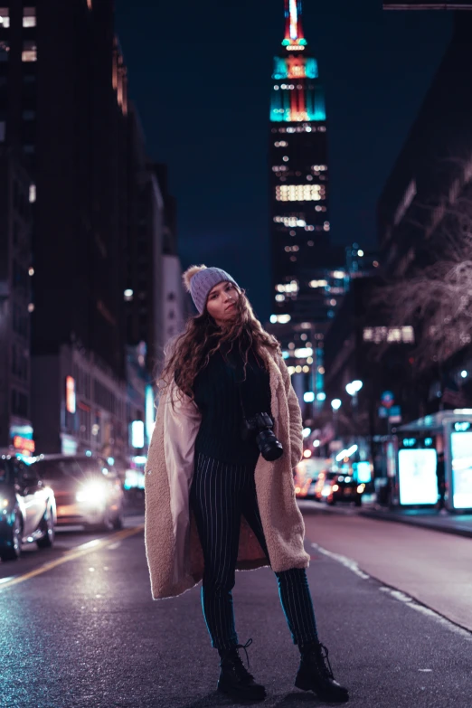 a person is standing in the middle of a city at night