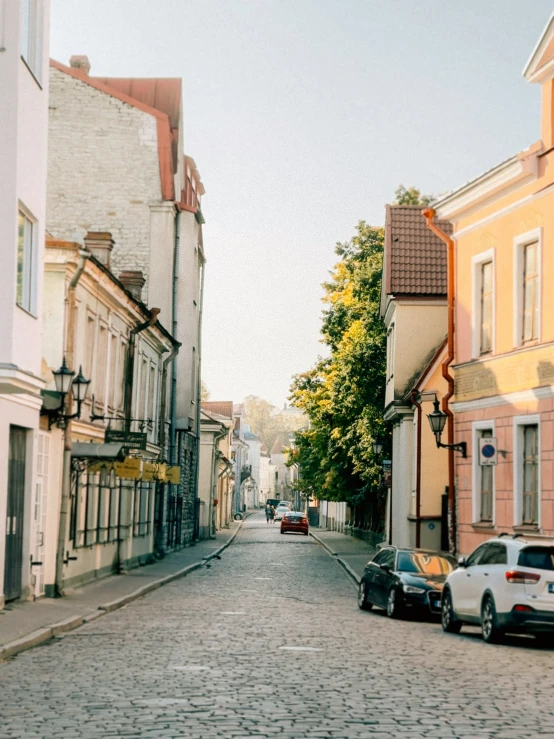 several cars are parked on a small street