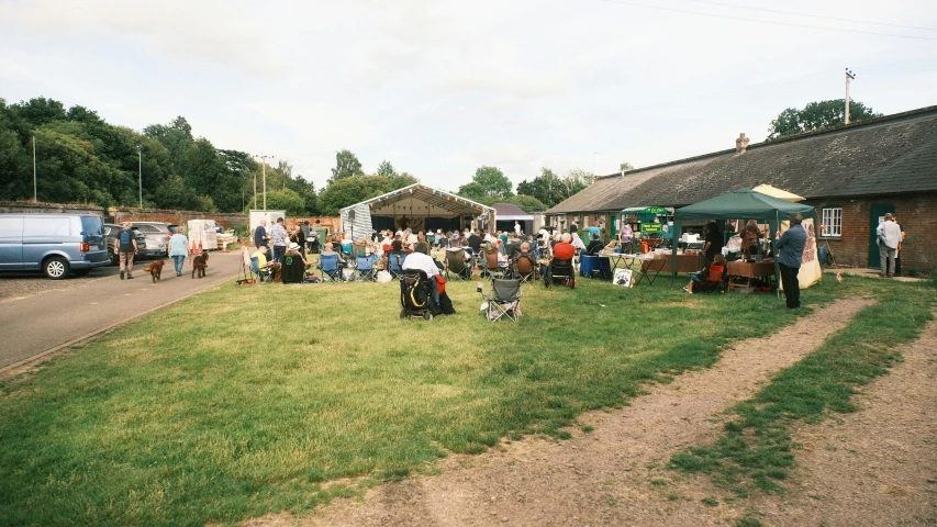 a group of people standing outside on top of a field