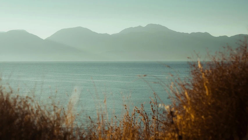 a small body of water surrounded by mountains