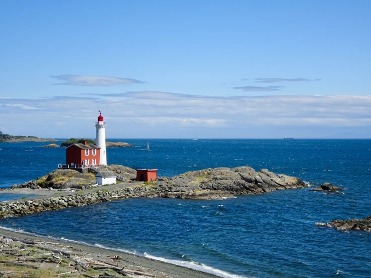 the lighthouse is on top of an island by the water