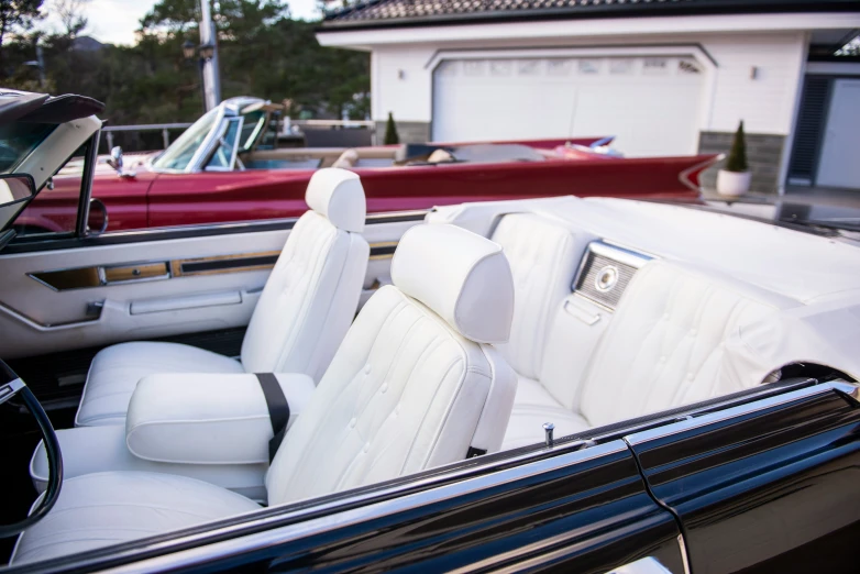 a very clean white car with a black seat cover