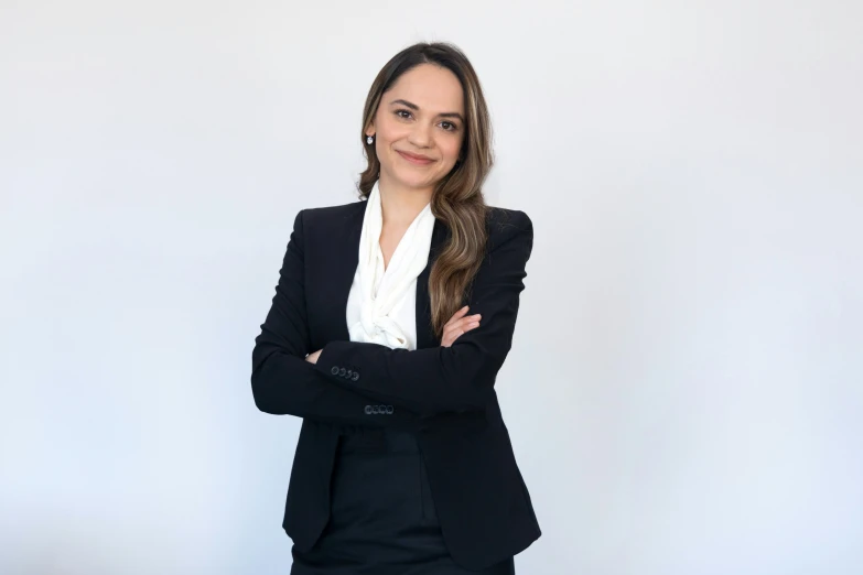 woman in business suit posing with arms crossed