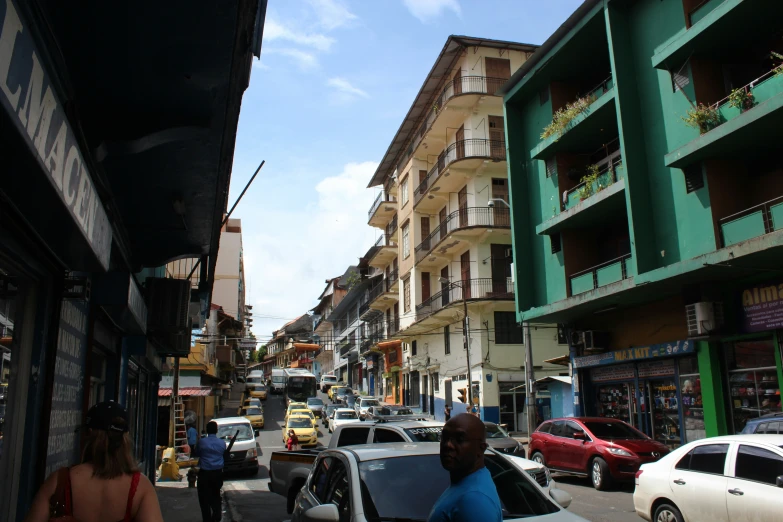 several cars are driving down a busy city street