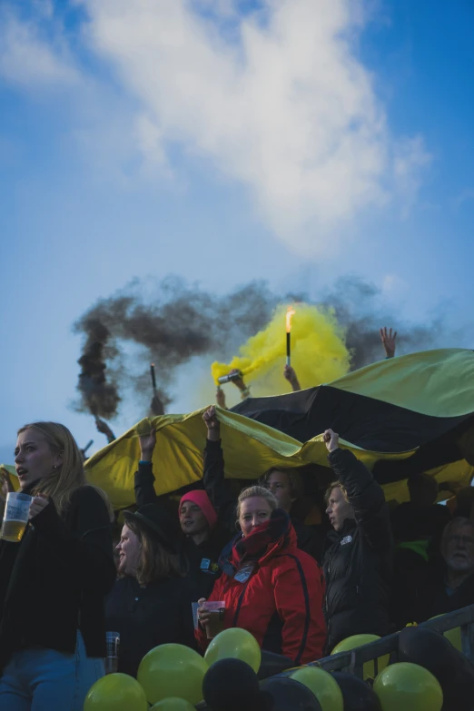 some people are sitting down and blowing smoke