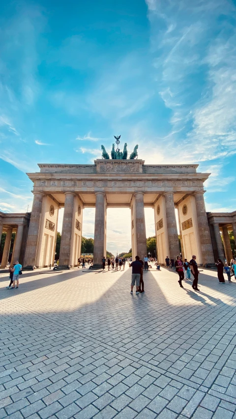 tourists are standing around a very tall building