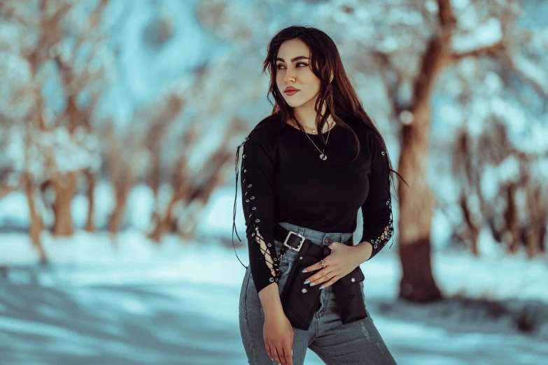 a beautiful young woman with long black hair and boots