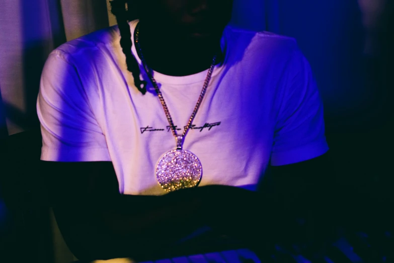 a person in a dark room with the keyboard in front of him