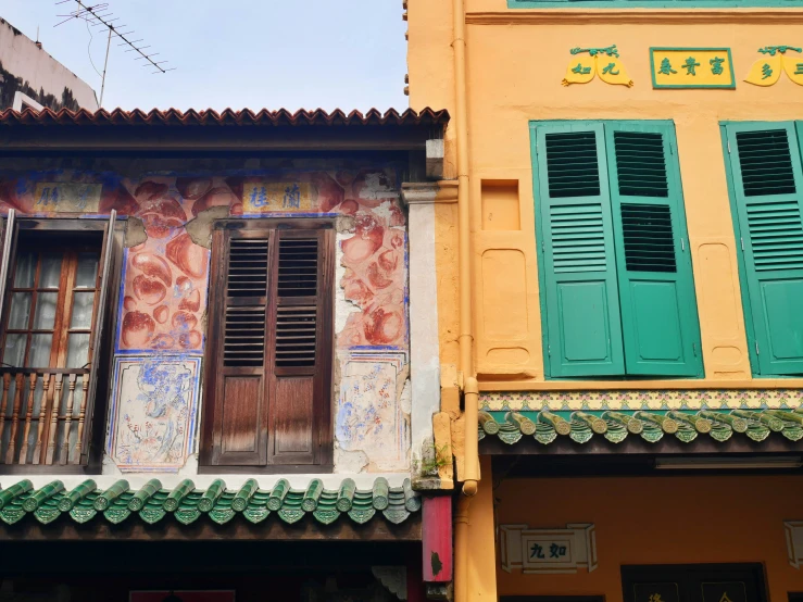 a building with several colorful shutters and windows