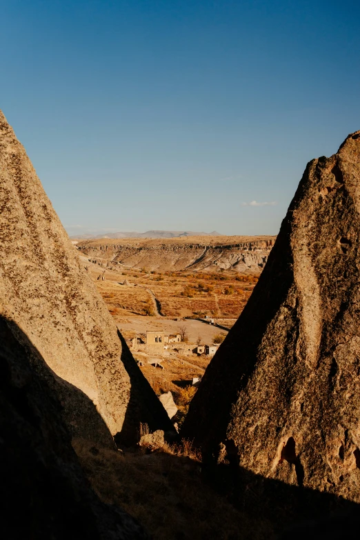 a couple of very large rocks by some big hills